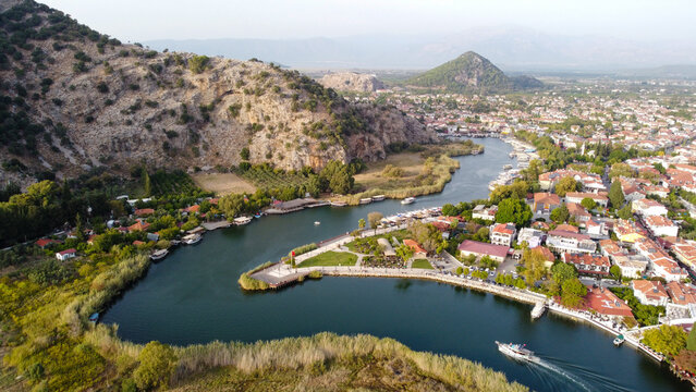 Aerial High Angle View of Dalyan River Canal and Town with Mountains and Boats in Mugla Turkey