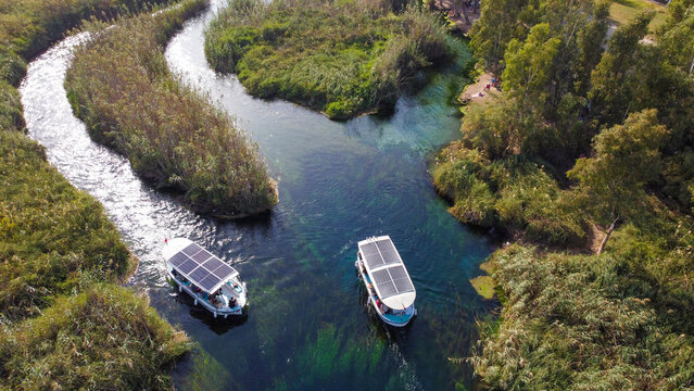 Aerial Top Down View of Crystal Clear Azmak River with Tour Boats and Reeds in Akyaka Turkey