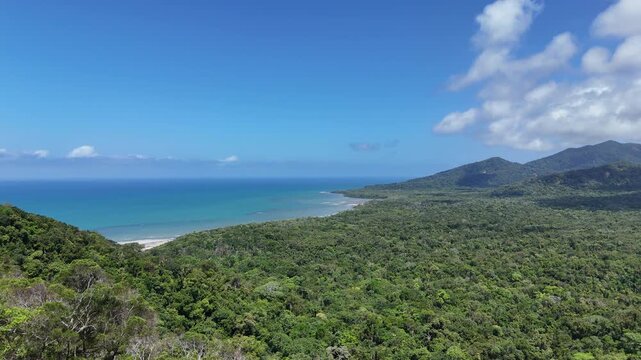 drone shot of beautiful bloomfield road through the daintree rainforest near cape tribulation along the tropical coastline of the pacific ocean in Queensland, a popular travel destination in Australia