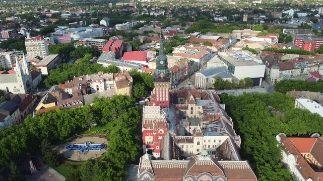 Drone moves forward to reveal an aerial view of Subotica historic city center in northern Serbia.