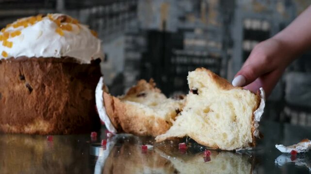 Soft Easter breads tasting moment as female hands tear and eat fluffy paska kulich and colomba enjoying fresh sweet crumb in cozy festive atmosphere