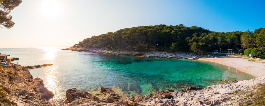 Panoramic view of Veli Zal bay on Losinj island during golden hour with warm sunset light.