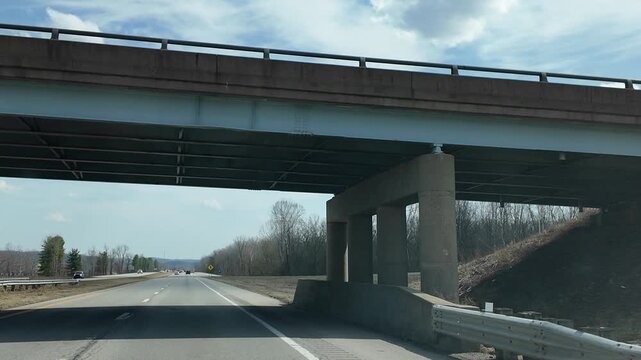 School Busses Driving on Overpass Viewed From Below in Daytime