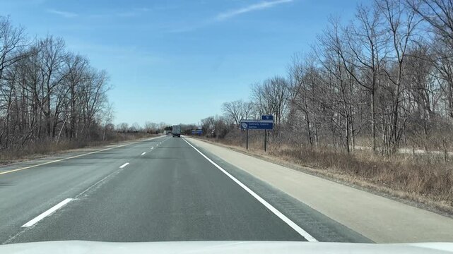 Truck Travels Down Highway in Spring Weather Conditions