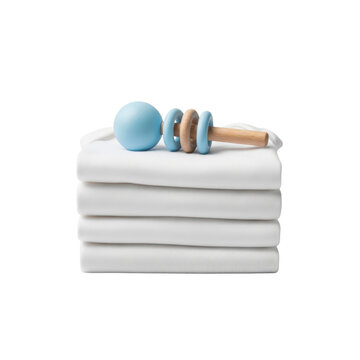 Baby rattle on stack of white cloths