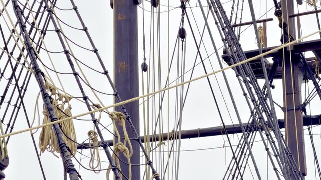 Upward pan from the deck to the mast top of Etoile du Roy in Saint Malo, Brittany, France, revealing rigging lines and the crow&rsquo;s nest lookout platform above