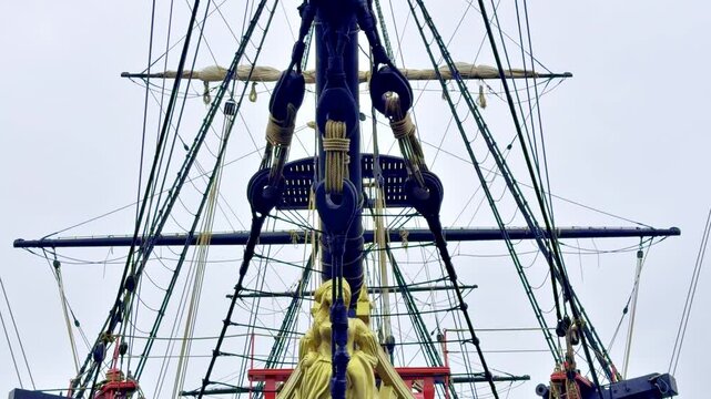 Close view of the Etoile du Roy figurehead and bow rigging in Saint Malo, Brittany, France, showing the bowsprit, ropes, blocks and classic fittings of a historic wooden sailing ship