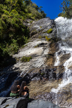 Mountaineers in front of a waterfall in the eastern part of Waraira Repano National Park in Guatire. Hiking in Latin America and the Caribbean. Exploring Venezuela