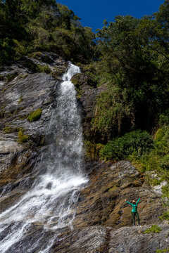 Latina mountaineers in front of a waterfall in the eastern part of Waraira Repano National Park in Guatire. Hiking in Latin America and the Caribbean. Exploring Venezuela