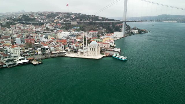 Grand Mecidiye Ortakoy Mosque with martyrs bridge in the back cirle around shot