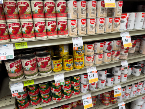 Canned Tomato Products And Sauces Display On Grocery Store Shelf