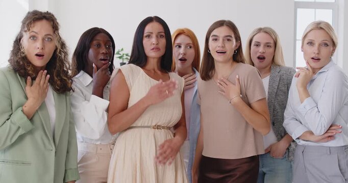 Women group show shock and surprised reaction. People friends together indoors, in disbelief, mid gasp, showing emotion and unity after sudden news. Concept collective surprise and disbelief.