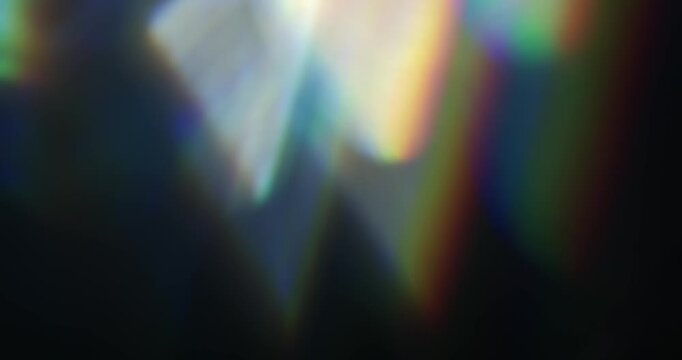 Real rainbow of light leaks through prism in a seamless loop. Lens flares through glass in vibrant chromatic aberration colours. Optical effect of shining light rays in a brilliant spectrum of colors
