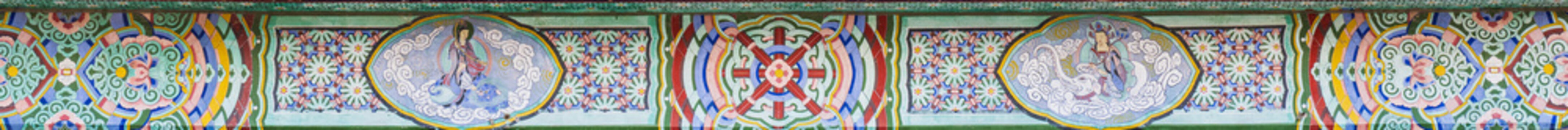 Intricate Buddhist mural paintings and colorful dancheong patterns on traditional Korean temple eaves
