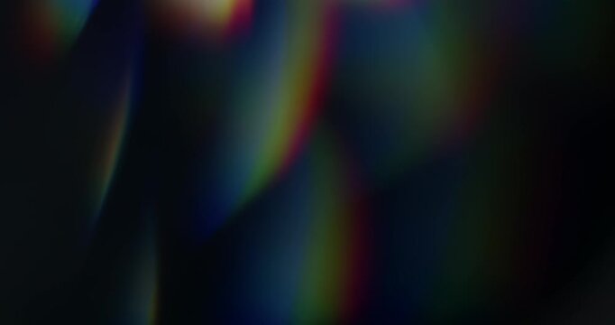 Real rainbow of light leaks through prism in a seamless loop. Lens flares through glass in vibrant chromatic aberration colours. Optical effect of shining light rays in a brilliant spectrum of colors