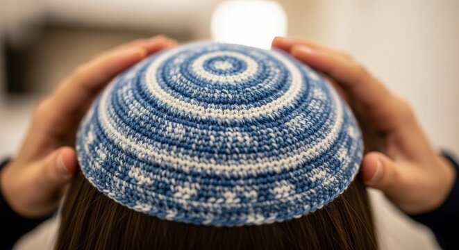 Woman wearing blue and white kippah.