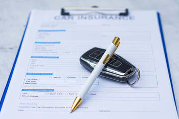 Car insurance document with vehicle key and pen on clipboard. Concept of auto insurance policy, contract signing, vehicle protection, coverage and financial responsibility. © vadish