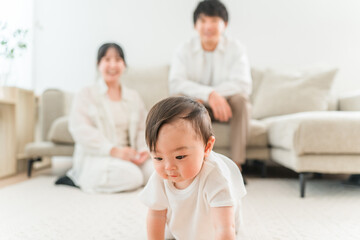 Fototapeta premium Families with young children and babies playing in their living room at home (childcare, parenting, physical contact)