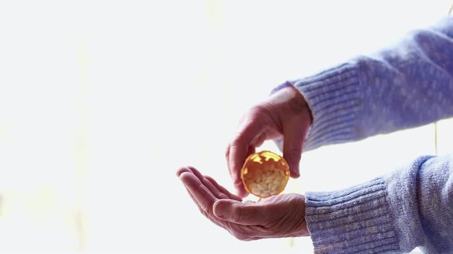 Senior Woman Spreading Cheese on Crackers Close Up