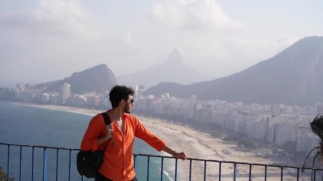 Traveler with backpack overlooking beach in Rio de Janeiro
