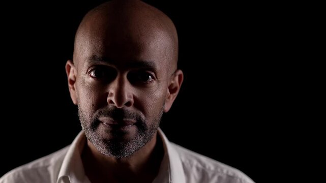 Identity crisis and mental health issues Portrait of a man with two heads on a black background representing split personality and dissociative identity disorder commercial editorial and documentary.