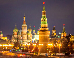 Obraz premium Moscow Kremlin illuminated at night with colorful domes and glowing streetlights creating a vibrant cityscape with