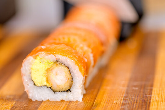 Maki roll with salmon and shrimp tempura showcasing nikkei fusion cuisine