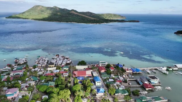Flyover drone shot above a coastal informal settlement in Linapacan Island, Philippines