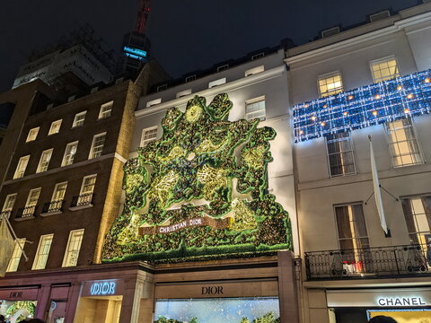 Festive holiday lights on the Christian Dior boutique facade on New Bond Street in London at night