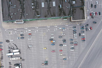 shopping mall parking lot with parked cars. aerial top view from flying drone.