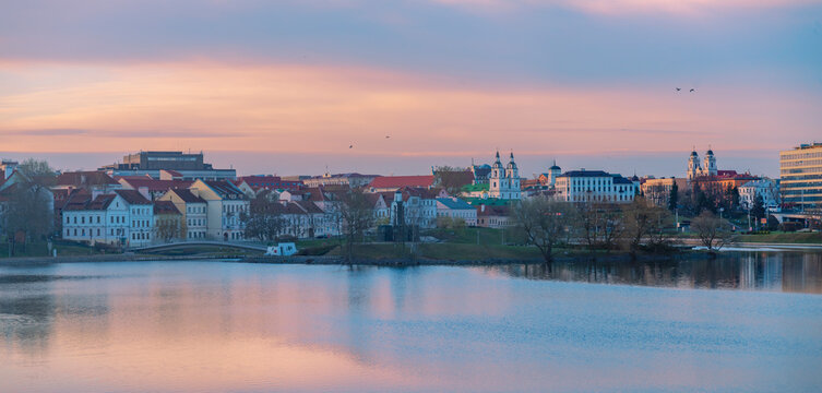 Panoramic Minsk Cityscape at Dawn with Trinity Suburb and River Reflection with copy space