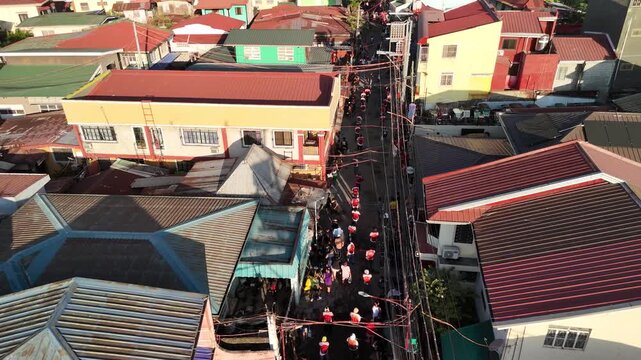Aerial drone footage of Filipino SinaKulo Pinetensya during Holy Week in front of a parish church, highlighting powerful religious devotion and cultural heritage. Captures dramatic passion play