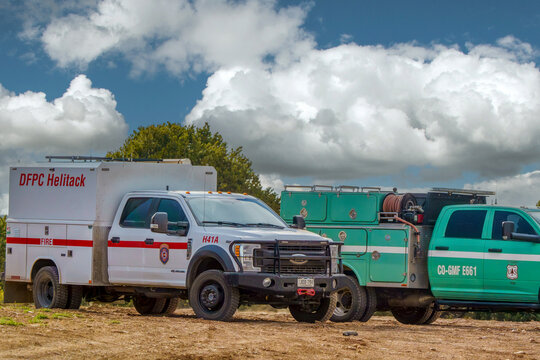 White DFPC Helitack truck and a green US Forest Service wildland engine