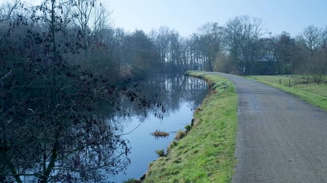 Tranquil misty morning landscape with river and path