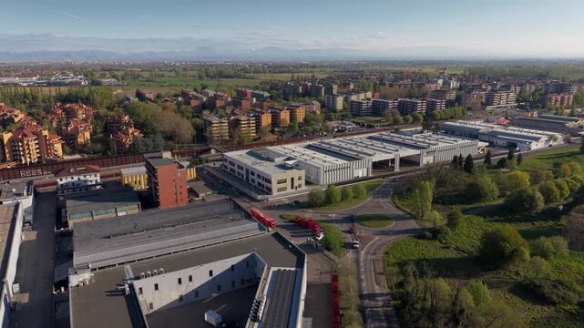 Industrial Area Overview: An expansive aerial view captures a sprawling industrial zone with large warehouses, factories, and connecting roads.