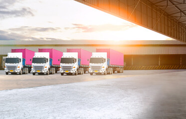 Semi Trailer Trucks on the parking lot at Warehouse. Shipping Cargo Container. Trucks Loading Goods...