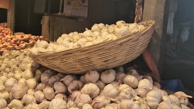 Fresh Organic Garlic Bulbs Displayed in a Wicker Basket at a Local Market
