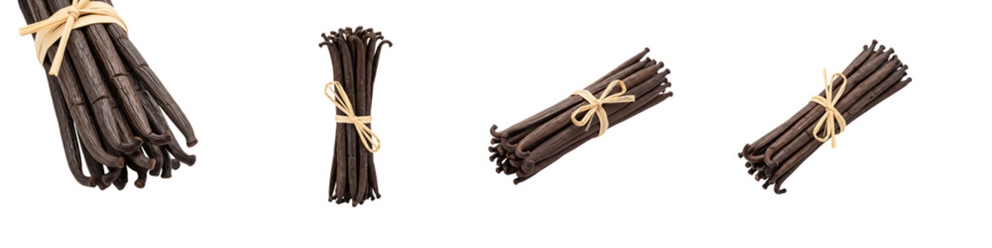 Collection of aromatic vanilla bean bundles tied with raffia on black
