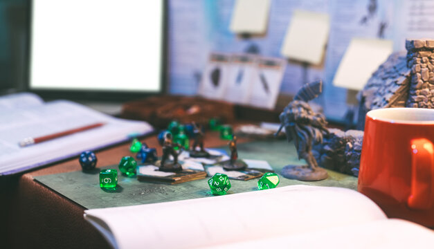 Dice create fantasy adventure narrative story role playing tabletop game and board games miniatures and laptop on background