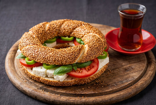 Appetizing turkish simit bagel sandwich with cheese tomato and basil