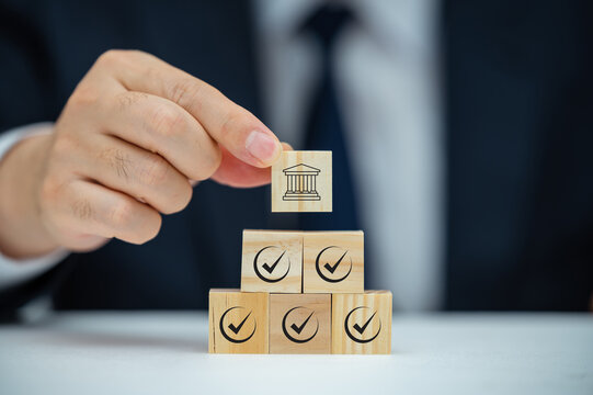 Regulation and good governance for transparent, accountable, and sustainable business operations. Wooden blocks with check marks, symbolizing corporate regulatory and compliance, ethical corporate.