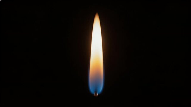 candle flame close-up in darkness, blue base, warm orange glow