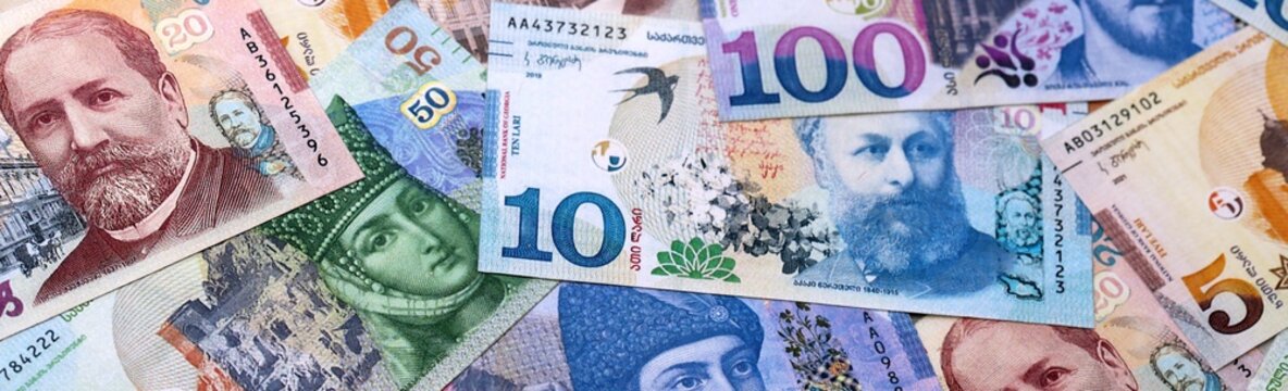 Georgian lari money bills pile on table. Georgia banknotes of GEL currency close up.