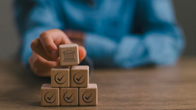 Regulation and good governance for transparent, accountable, and sustainable business operations. Wooden blocks with check marks, symbolizing corporate regulatory and compliance, ethical corporate.