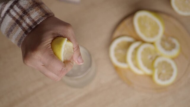 Making fresh lemonade with lemon and hand squeezer