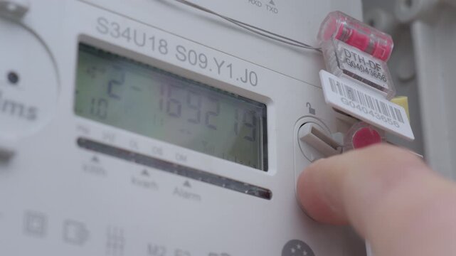 Close up of digital electricity meter display in utility box. Concept of power consumption energy measurement monitoring and household utility management.