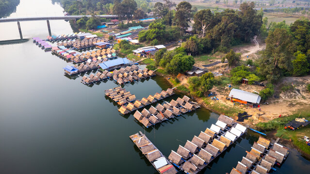 A tourist destination, a holiday retreat, a river, trees, a perfectly balanced and beautiful landscape, eco-friendly relaxation, photographed from a drone.