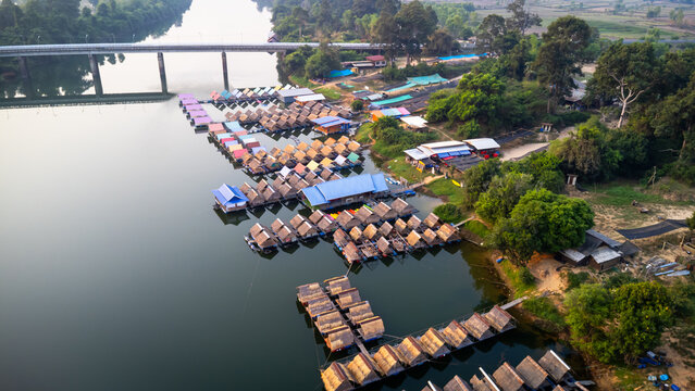 A tourist destination, a holiday retreat, a river, trees, a perfectly balanced and beautiful landscape, eco-friendly relaxation, photographed from a drone.
