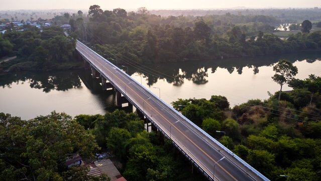 A tourist destination, a holiday retreat, a river, trees, a perfectly balanced and beautiful landscape, eco-friendly relaxation, photographed from a drone.