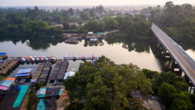 A tourist destination, a holiday retreat, a river, trees, a perfectly balanced and beautiful landscape, eco-friendly relaxation, photographed from a drone.